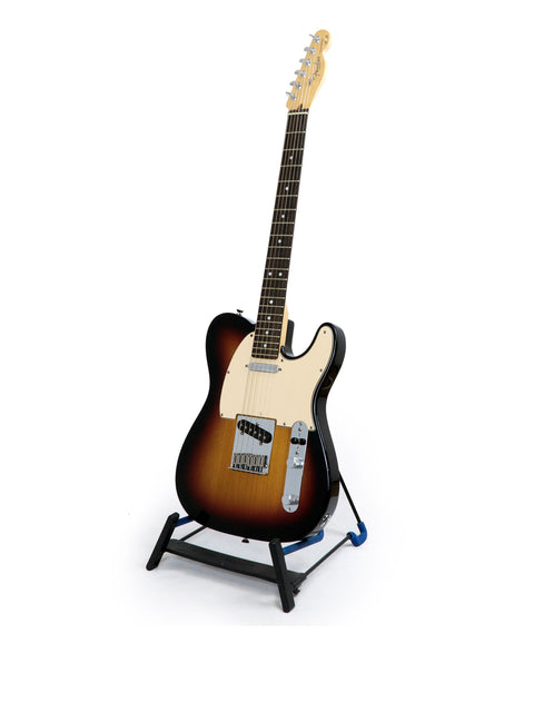 Sunburst electric guitar on a stand, isolated on a white background.