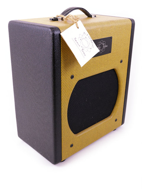Swart Atomic Space Tone Amplifier in yellow and black, 2008 model, with a visible tag on its surface.

