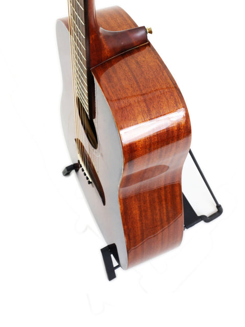 The 2019 Alvarez MDA66SHB guitar rests on a stand, highlighting its stunning wooden body and craftsmanship.