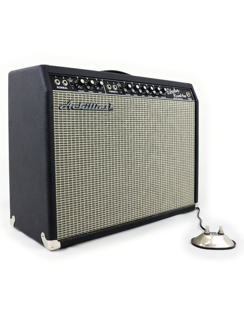 The Achillies Vibrolux Reverb Combo Amp, a 2021 model, complements a Fender Stratocaster guitar with its stylish and powerful design.