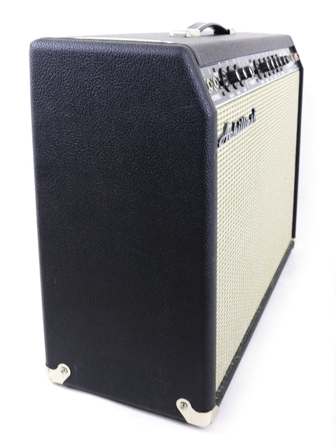 The Achillies Vibrolux Reverb Combo Amp in black and white, set against a white backdrop, highlighting its classic amplifier style.