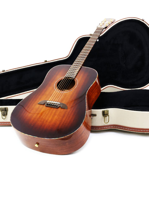 The Alvarez MDA66SHB acoustic guitar with its case, elegantly positioned against a bright white background for a striking look.