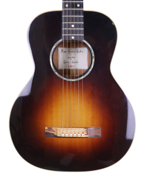 The Beau Hannam Parlour guitar from Australia, 2009, features a stunning sunburst finish that highlights its elegant design.