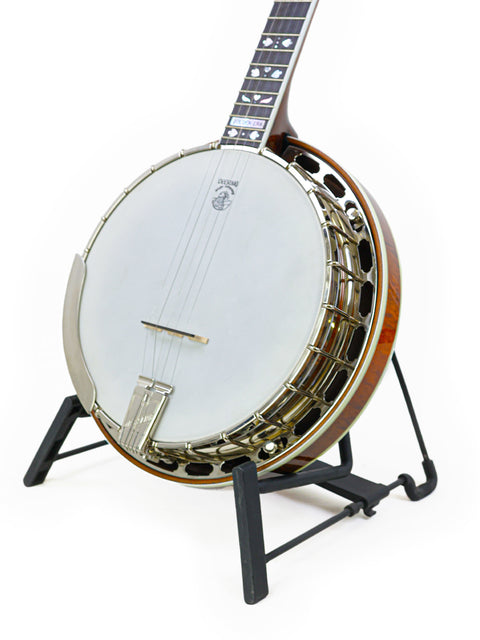 The Deering Golden Era Banjo, made in the USA in 2008, is displayed on a stand, highlighting its beautiful finish.