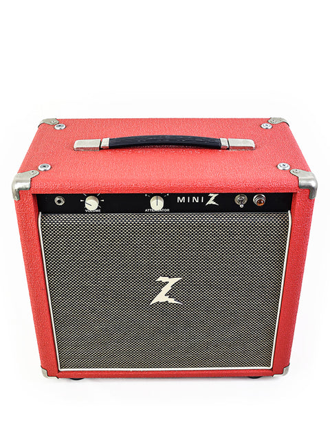 The Dr. Z Mini Z Combo, a striking red guitar amplifier, rests elegantly on a white surface, highlighting its modern aesthetic.