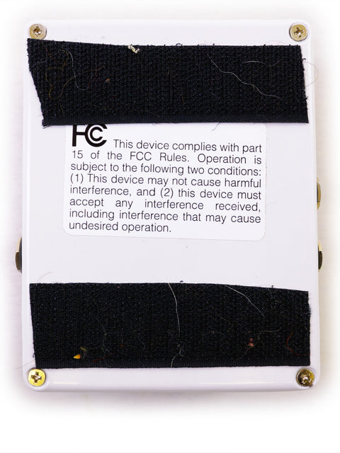 The Electro Harmonix B9 Pedal in a white box, secured with black tape, highlighting its sleek packaging.
