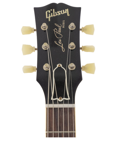  The Gibson Les Paul Classic in black, featuring a stunning finish and classic design, part of the 2019 Custom Shop collection.
