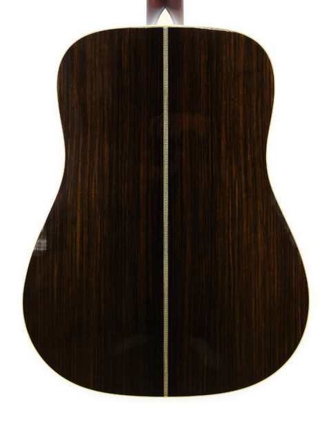The back of a 2006 Collings D2H acoustic guitar displayed on a white background, highlighting its craftsmanship and wood grain.
