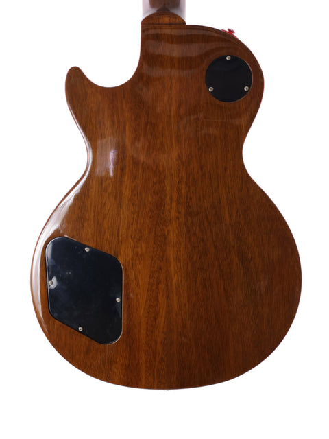 The back of a 2013 Gibson Les Paul Traditional guitar, featuring a stunning wooden body design.
