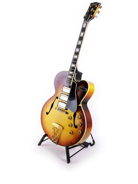 The iconic 1959 Gibson ES-5 Switchmaster guitar rests on a stand, highlighting its timeless craftsmanship and beauty.
