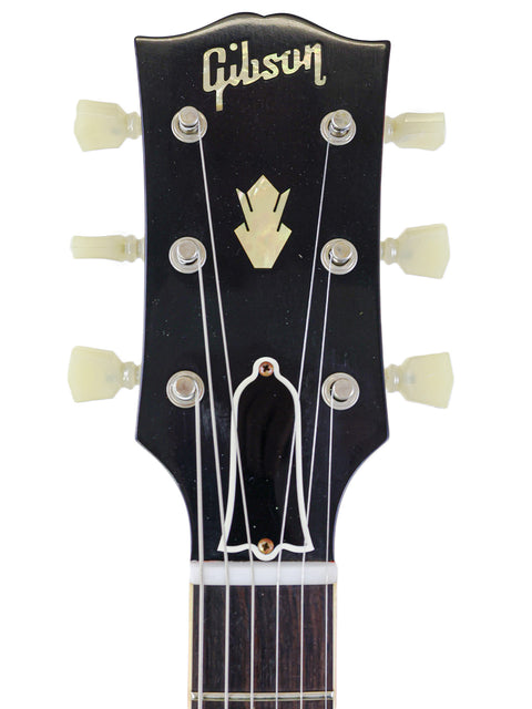 The iconic black Gibson Les Paul Custom Shop guitar, highlighting its premium features and craftsmanship from the 2020 USA edition.
