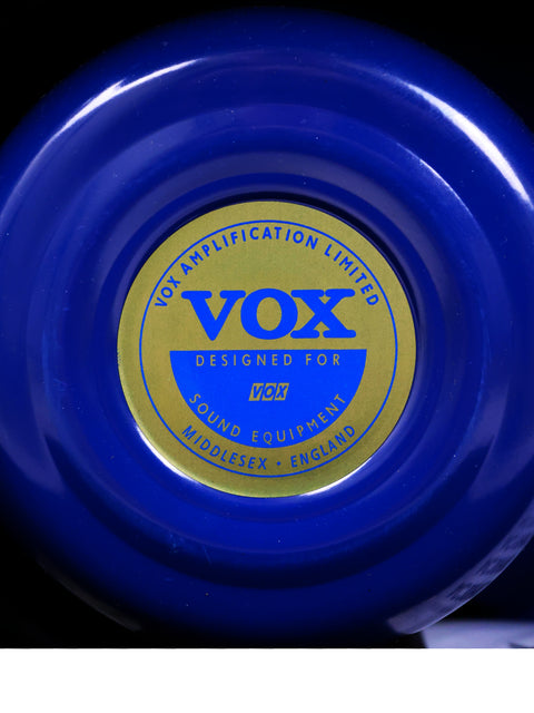 The iconic blue and gold Vox logo displayed on the 2021 AC30 HW2X amplifier, a testament to musical excellence.