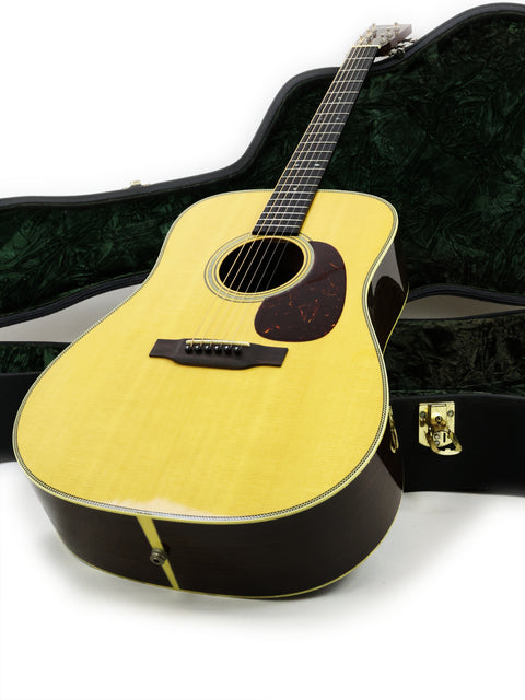 The image features a 2006 Collings D2H guitar securely placed in a green and black case, emphasizing its classic appeal.