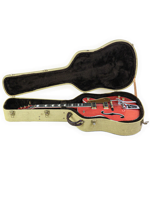 The image features a red guitar case with a black and gold Gretsch 6120DE Duane Eddy Signature guitar from Japan, 1997.