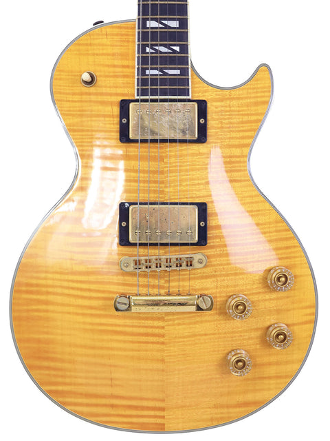  The image features a yellow-bodied electric guitar, specifically a 2003 Gibson Les Paul Supreme made in the USA.
