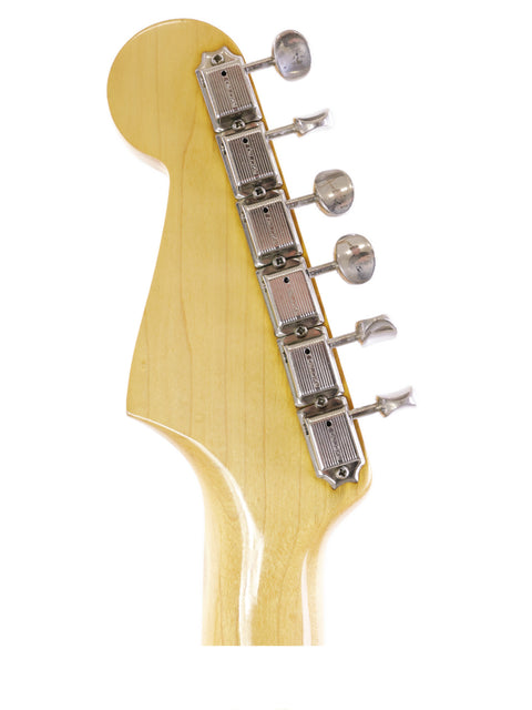 The neck of a 1964 Vintage Fender L Series Stratocaster in Fiesta Red, exemplifying timeless electric guitar design.