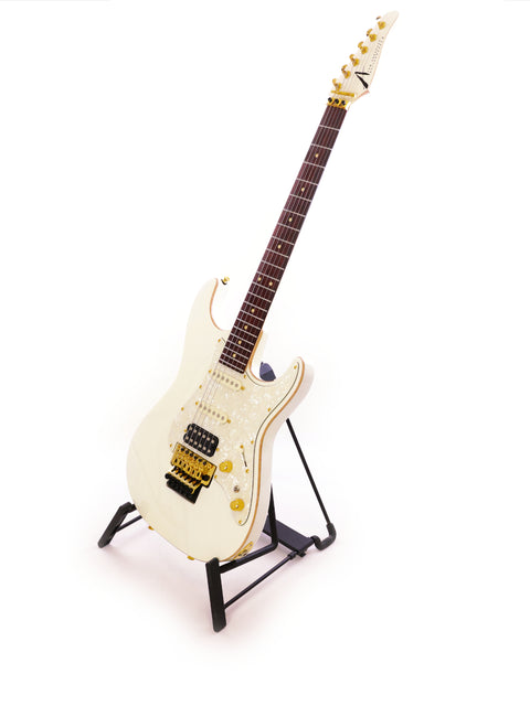 Tom Anderson Drop Top Classic guitar in white on a black stand, presenting a striking contrast and modern design.