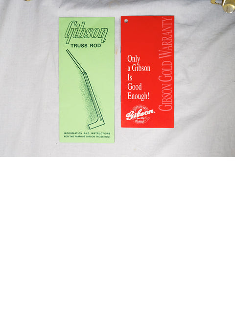 Two bookmarks inscribed with "gilson," accompanied by a 1997 Gibson Custom Shop Le Grand Archtop guitar from the USA.

