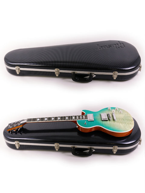 Two guitars, a Gibson Les Paul HP from 2019, resting in a case against a clean white background.