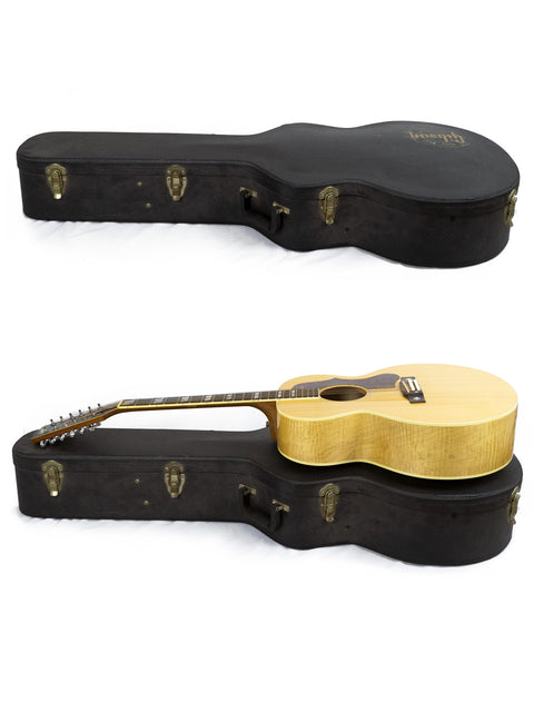 Two guitars, featuring a 2000 Gibson J-185-12 String, nestled in a case with a white background.