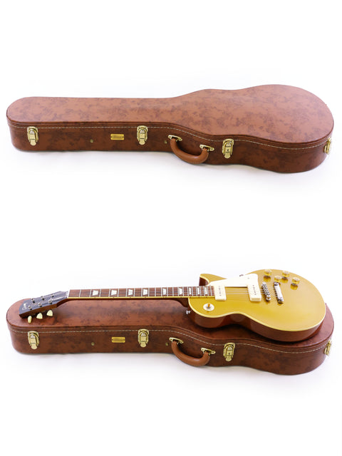 Two guitars in a case, featuring a striking gold body, showcasing the Gibson Custom Historic VOS LPR-6 1956 Reissue.
