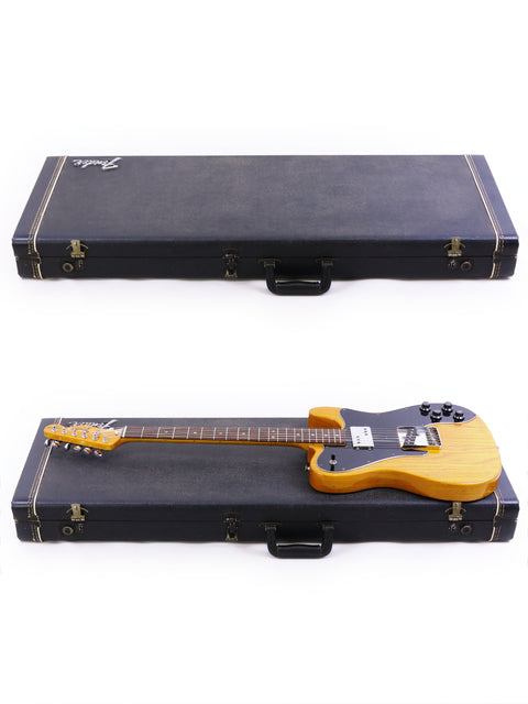 Two guitars, including a 1977 Fender Telecaster Custom, displayed in a case on a bright white background.
