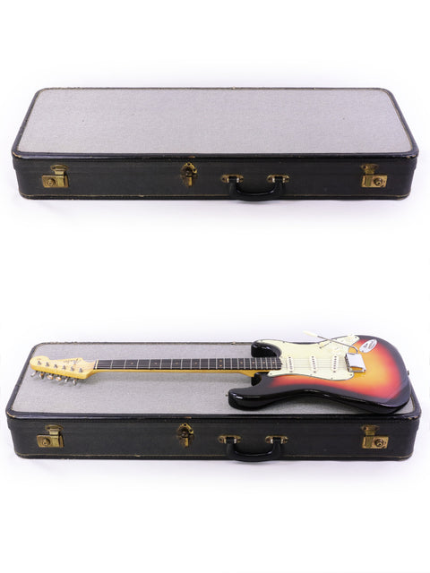Two guitars, one a 1964 Fiesta Red Fender L Series Stratocaster, housed in a case on a clean white background.