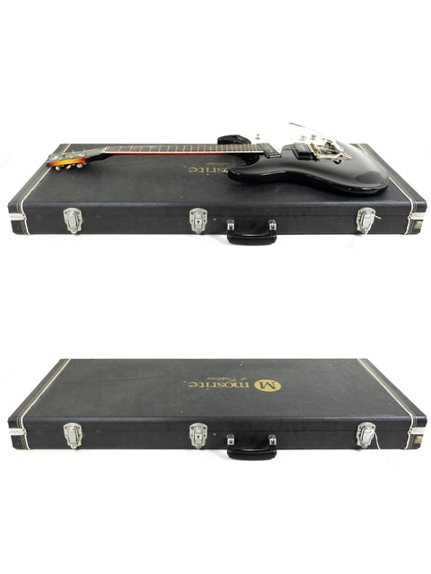 Two vintage Mosrite guitars in a case, displayed on a white background, showcasing their classic 1990s design.