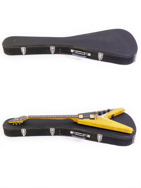 Two yellow-cased guitars on a white backdrop, showcasing an Ibanez 2387CT Rocket Roll Sr. Flying V from Japan, 1976-77.