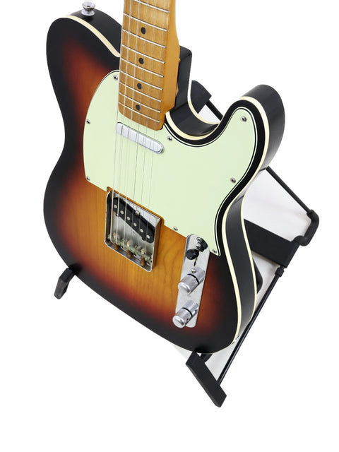 Txxx Custom Style Partscaster guitar with a black body and a vibrant sunburst neck, crafted in 2021.
