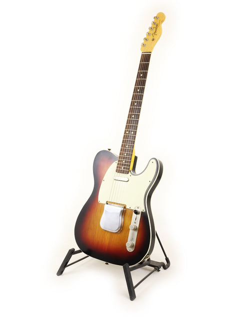 Txxx Custom Style Partscaster guitar with a vibrant sunburst finish, elegantly displayed on a stand.