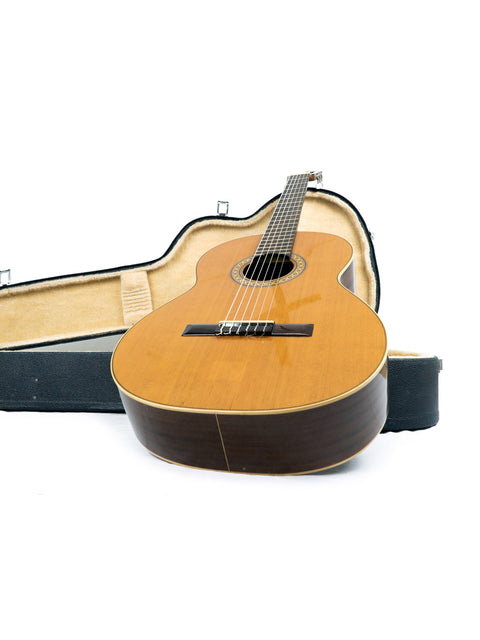 Vicente Sanchis Model 34 Classical guitar from 1979, nestled in its case on a white surface.