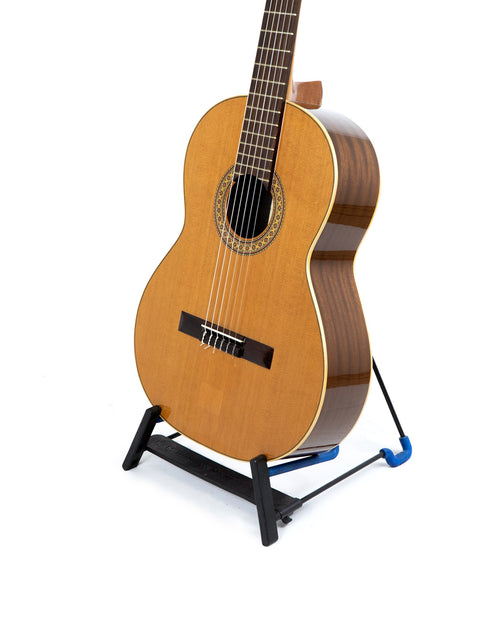 Vicente Sanchis Model 34 Classical guitar from 1979, resting on a blue stand, emphasizing its vintage appeal.