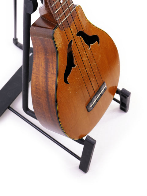 Vintage 1927 Harmony Roy Smeck Vita-uke ukulele displayed elegantly on a stand, perfect for music lovers and collectors.
