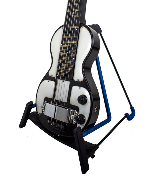 Vintage 1930s Rickenbacher Electro Lap Steel guitar displayed on a stand with a white backdrop.
