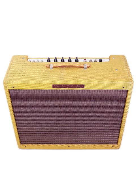 Vintage 1957 Fender Twin Reissue guitar amplifier in yellow, featuring a stylish brown and black head for a classic look.