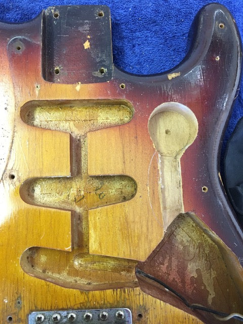 Vintage 1958 Fender Stratocaster with a broken neck and headstock, showcasing its worn and damaged condition.
