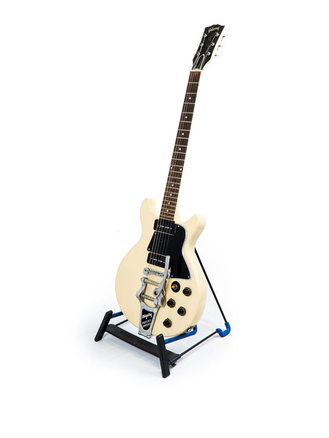 Vintage 1959 Gibson Les Paul Special Refin guitar in white, resting on a stand with a striking blue base.