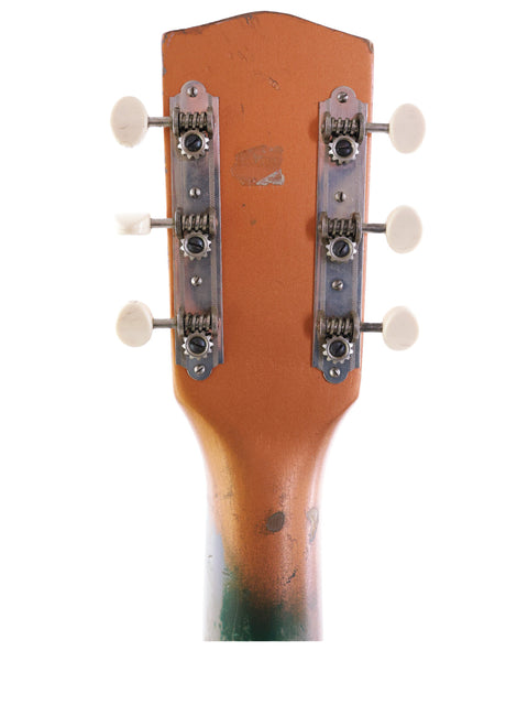 Vintage 1961 Gibson Les Paul Standard in green, highlighting its iconic features, paired with a 1955 Harmony H44 Stratotone guitar.
