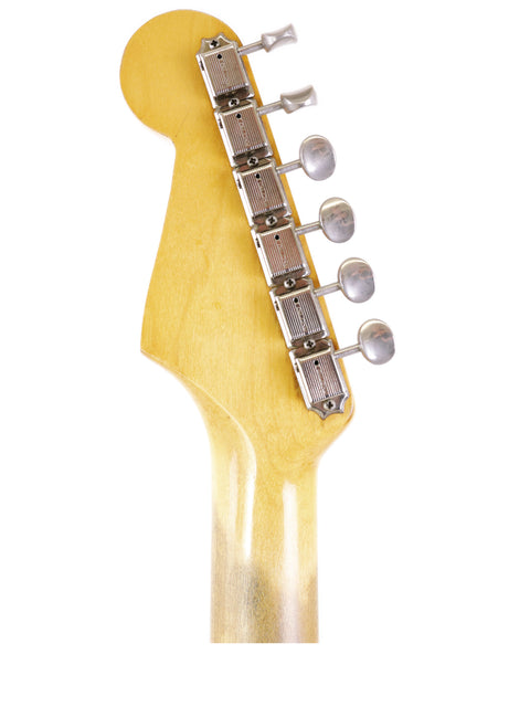 Vintage 1964 Fender L Series Stratocaster headstock in close-up, set against a bright white background.