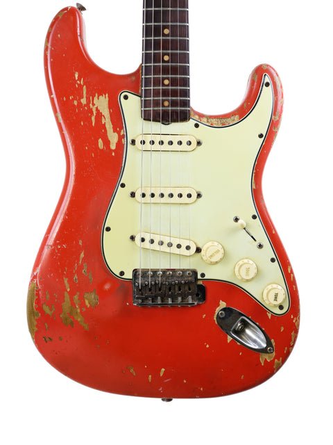 Vintage 1964 Fender L Series Stratocaster in Fiesta Red with a classic white pickguard, showcasing its iconic design.