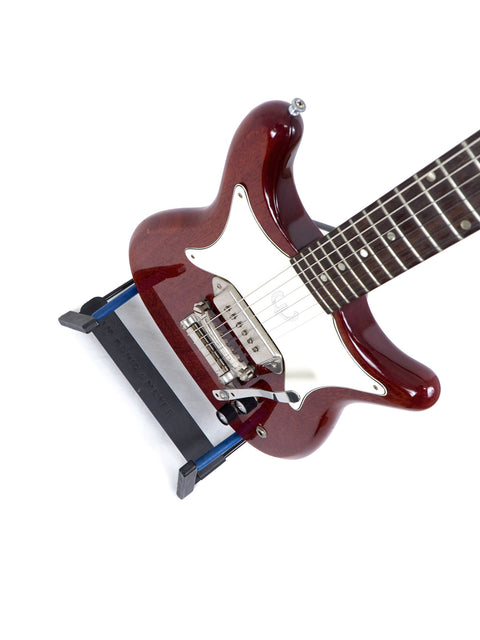 Vintage 1965 Epiphone Coronet guitar in red with a stylish black pick guard on top.