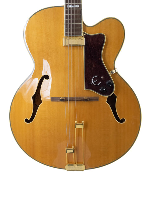Vintage 1965 Epiphone Coronet guitar with a rich brown body and striking gold neck, perfect for music enthusiasts.