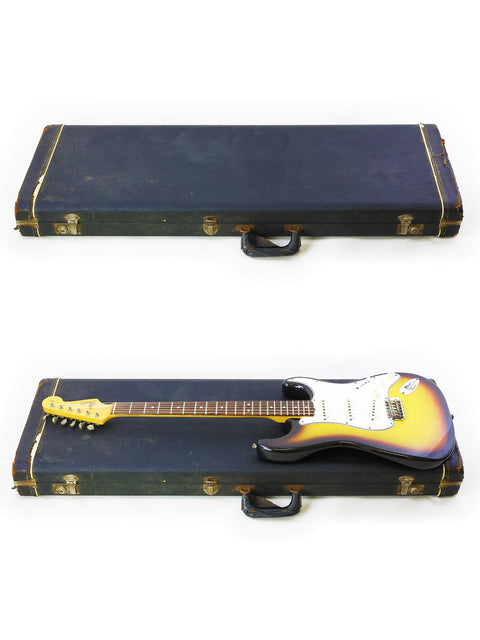 Vintage 1965 Fender Stratocaster guitars displayed in a case, contrasting beautifully with a white background.
