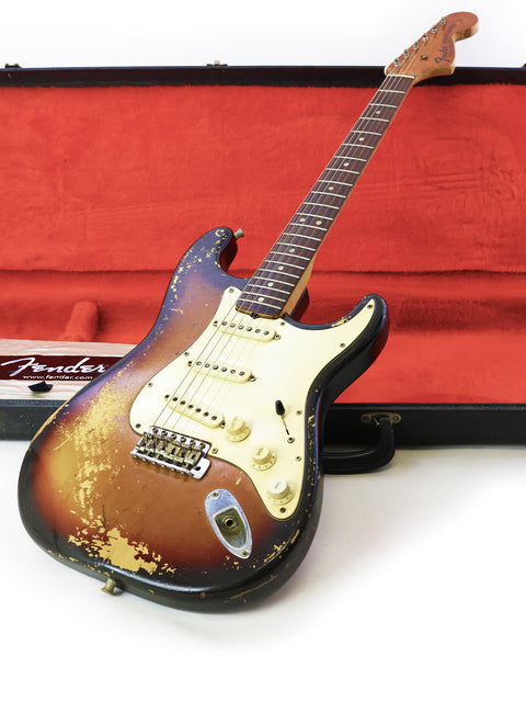 Vintage 1970 Fender Stratocaster in sunburst finish, securely placed in its case, ready for the next musical adventure.