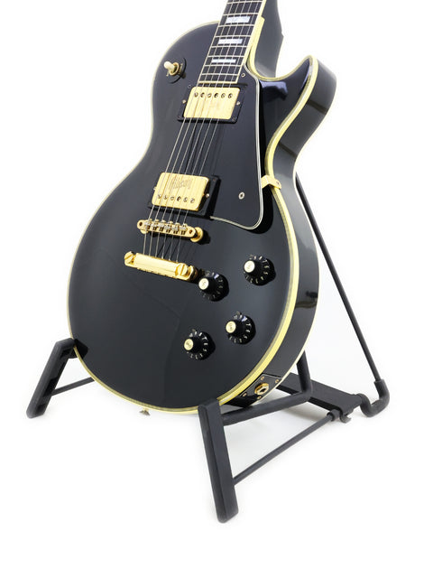 Vintage 1972 Gibson Les Paul Custom in black, showcased on a stand, highlighting its iconic design.