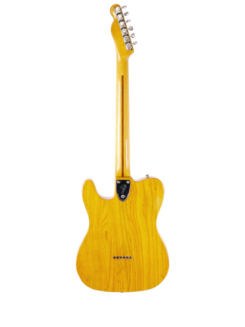 Vintage 1977 Fender Telecaster Custom in yellow, prominently displayed on a white background, highlighting its classic features.