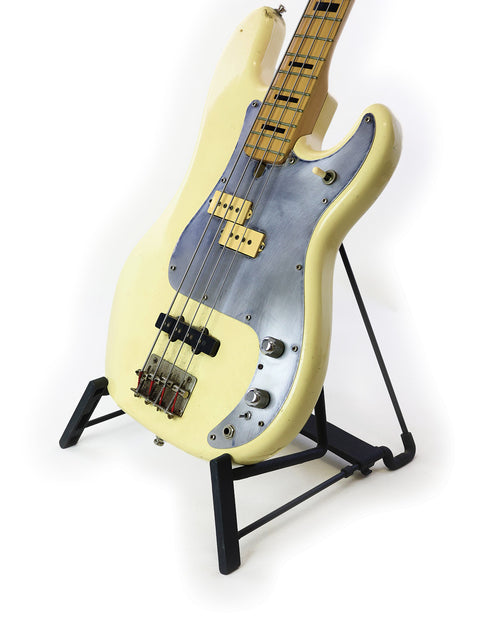 Vintage 1978 Ibanez Silver Series P/J bass guitar in white, elegantly positioned on a black stand.