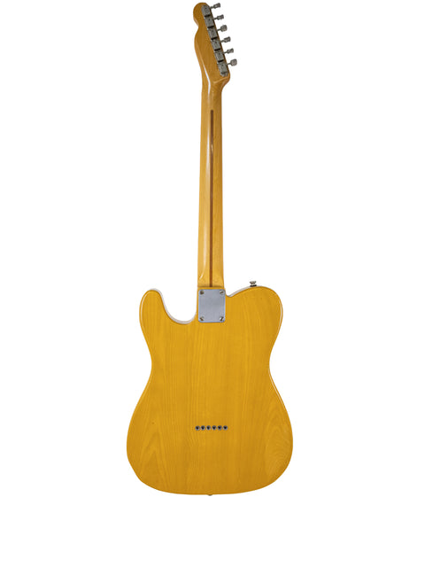 Vintage 1984 Fender Squier JV Telecaster in yellow, set against a stark white background, highlighting its classic appeal.