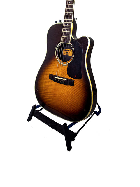 Vintage 1984 Washburn Mirage Deluxe guitar displayed on a stand, set against a bright white backdrop.
